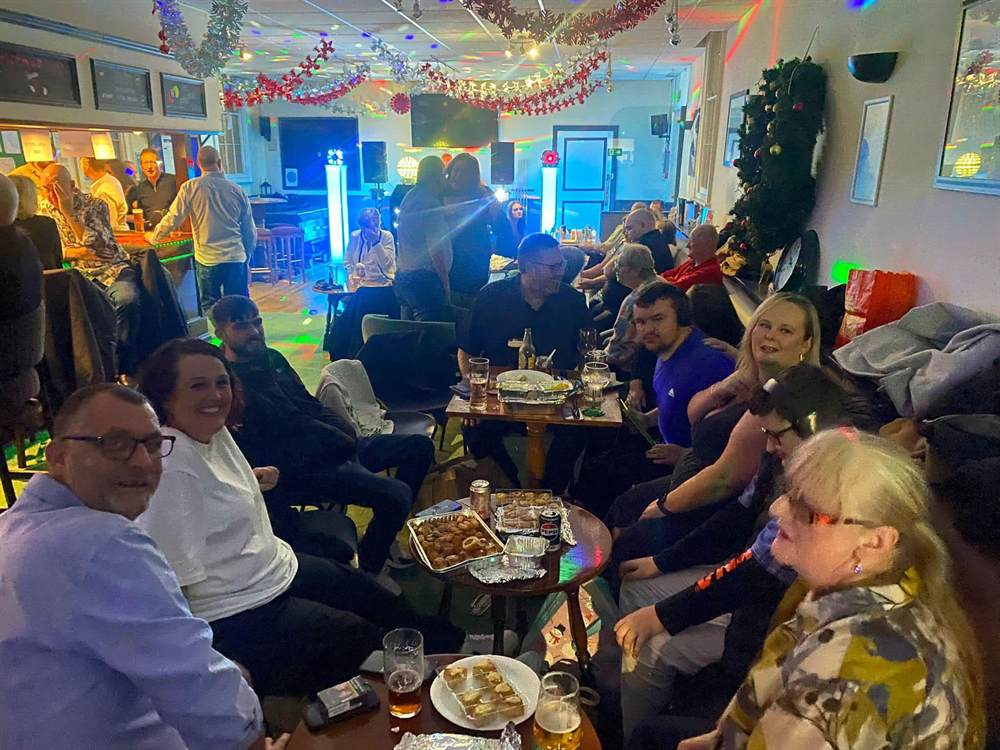 The Club decorated for Christmas, with members seated around tables
