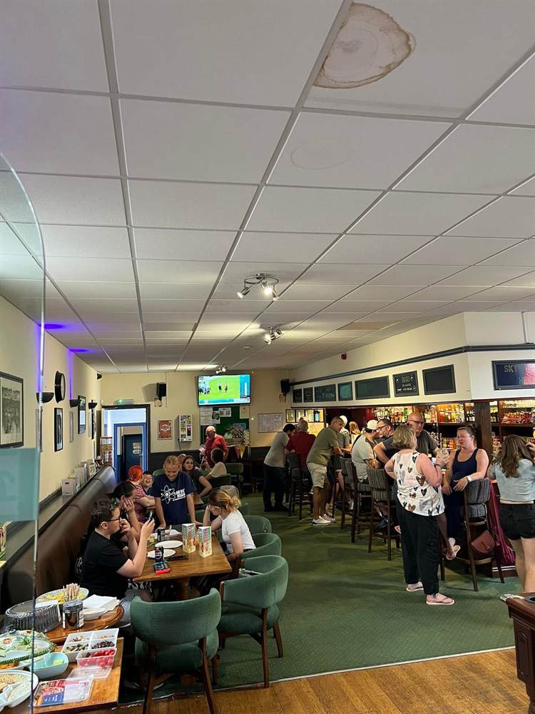 A family afternoon at the Club, with the bar busy and children at tables